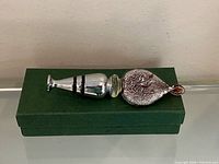 Stopper resting on closed presentation box