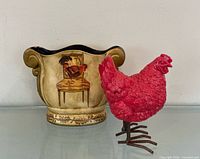 Planter front view with rooster motif next to red hen figurine