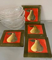 stack of four clear textured glass bowls beside four square pear trivets