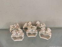 All four silver resin love bird napkin rings grouped