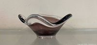 Side profile of freeform glass bowl showing amethyst interior and clear casing