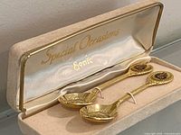 Open presentation box showing both gold plated teaspoons