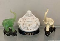 Front view of Buddha and both elephant figurines displayed together