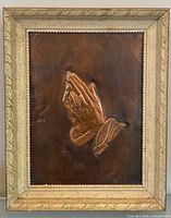 Full view of framed copper praying hands artwork