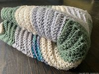 Blanket folded showing stitch detail and color stripes