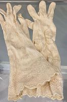 Both gloves showing lace pattern and scalloped cuffs
