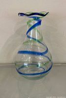 Full view of clear glass vase with blue and green spiral decoration