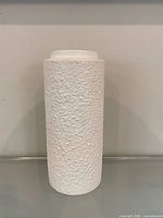 Front view of white textured cylindrical vase