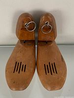 Top view of both wooden shoe trees showing ring pulls, ventilation slots and size marking