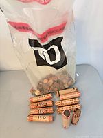 Bag of loose pennies and seven wrapped rolls