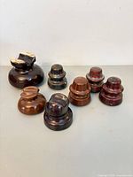 Seven ceramic insulators displayed on surface
