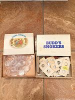 Both cigar boxes open showing coin capsules and cardboard flips