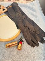 Opera gloves, mirror, figurine, lipstick novelty visible
