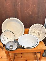 Group shot of all enamelware pieces displayed on chair