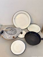 Group shot showing all seven enamel cookware and plate pieces