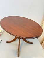Full view of oval side table on tripod base