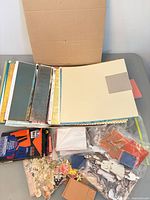 Box with assorted papers, stencils, die-cuts and tools