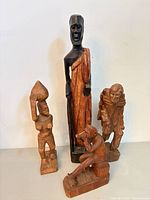Group view of all four wooden figurines