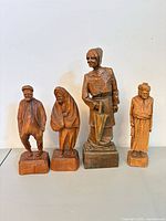 All four wooden figurines standing in a row