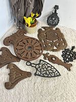 Group shot of all eight cast iron pieces on white surface