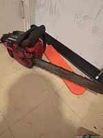 Left side view of Homelite chainsaw showing housing, bar and chain