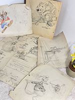 Overview of six sketch sheets laid out, showing characters and paper condition