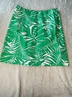 Front view of green palm leaf print skirt