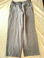 Full view of grey Lululemon pants laid flat showing overall style and condition