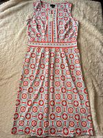 Full view of front of dress on flat surface displaying pattern and silhouette