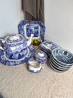 Group shot of all Spode Italian pieces with stacked Japanese bowls