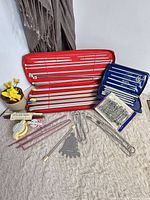 Overall view of cases, needles, gauge, pom-pom makers and accessories
