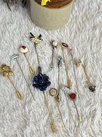 All 12 stick pins arranged showing variety of designs