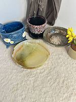 Group shot of onyx bowl, blue daisy planter, drip glaze holder, small vase