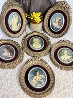 Five oval gold frames with portraits