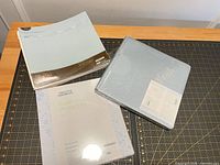 Three sealed Creative Memories items: album, refill pages, page protectors