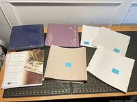 Overview showing both albums, stacks of pages labeled with counts, and packaged page protectors