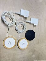 Two bamboo chargers, one black charger, two power adapters