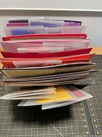 Top view of accordion folio packed with various colored paper sheets