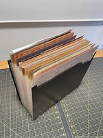 Accordion folio filled with paper viewed from spine side