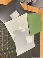 overview of several cardstock sheets showing grey, pearl, silver, green colours with product labels visible