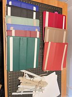 Overview of all album covers and strap hinges on table