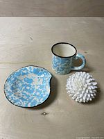 Cup, saucer and shell ornament grouped