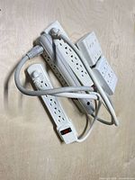 Group showing three power strips and two splitter adapters