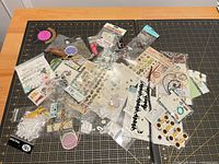 All embellishment packs spread out on cutting mat
