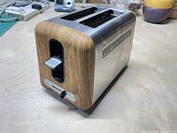 Front and side view showing wood finish, stainless body, two slots