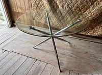 Top-down view showing full round glass surface and metal base layout