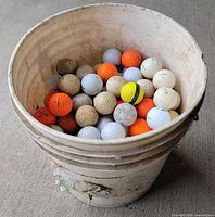 Bucket showing quantity of golf balls