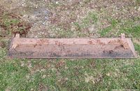 Top view of entire cast iron trough showing length and rusted surface