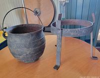 cauldron and stand side by side on table