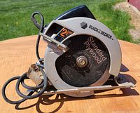 Left side view showing blade guard, 2 HP marking, plywood blade